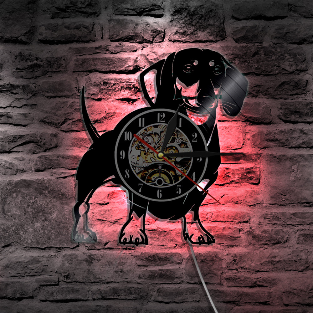 This Dachshund Vinyl LED Wall Clock is the perfect addition to any home or office. With a fun and quirky dachshund design, it's not only practical but a stylish statement piece. The LED lights create a warm and inviting ambiance, making it perfect for any room in the house or office. Also available without the LED light.